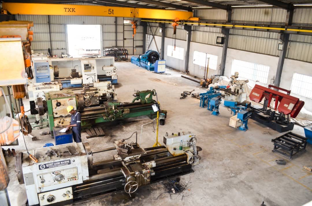 Wide view of the Reveille machine shop floor with lathes, milling machines and a 5-tonne overhead crane
